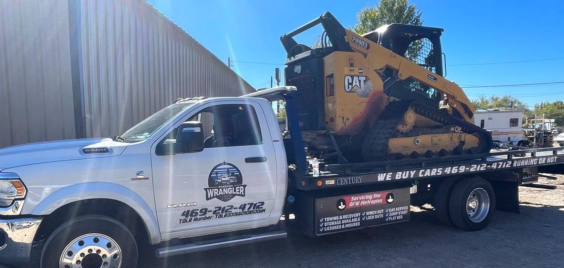 A silver Lincoln SUV being towed on a flatbed tow truck.