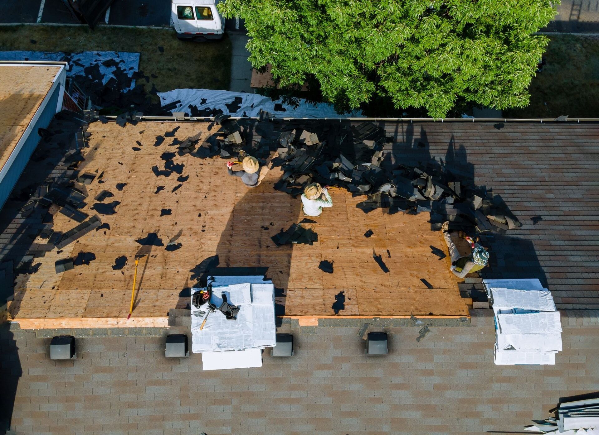An aerial view of a roof being repaired.