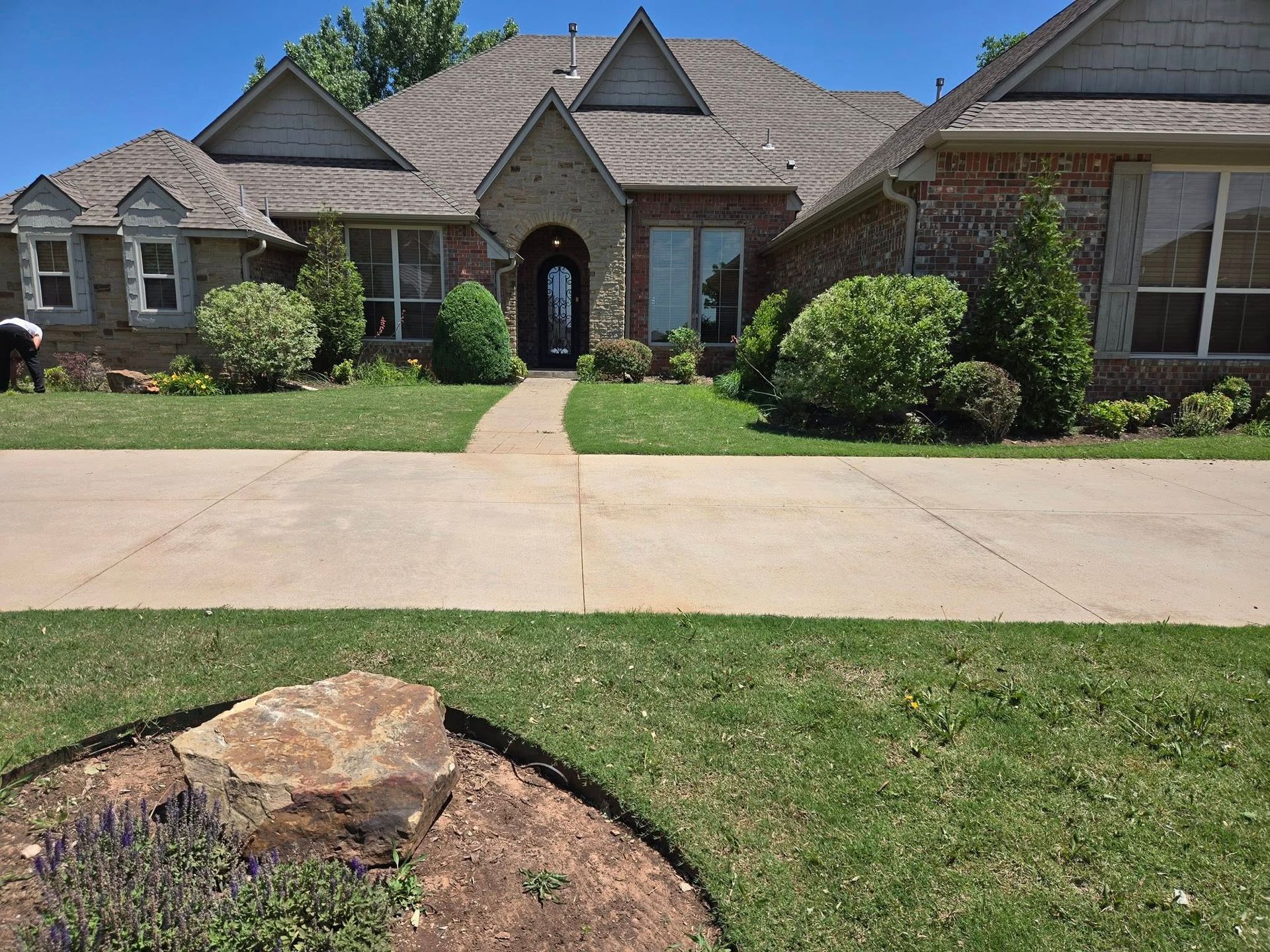 A large house with a lush green lawn in front of it