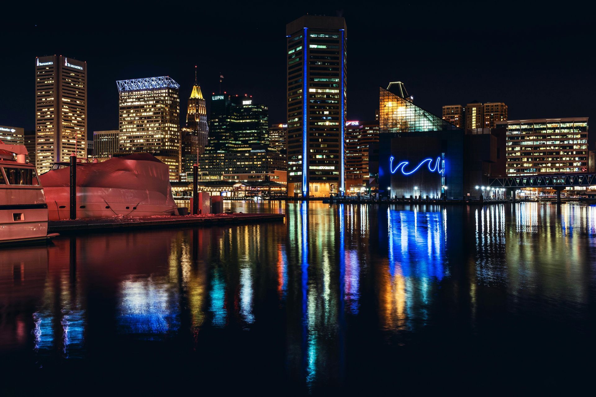 Baltimore Inner Harbor skyline and waterfront reflections at night in Maryland