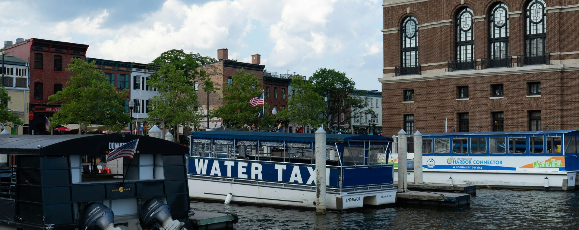 Baltimore Inner Harbor water taxi boats docked along the waterfront in Maryland.