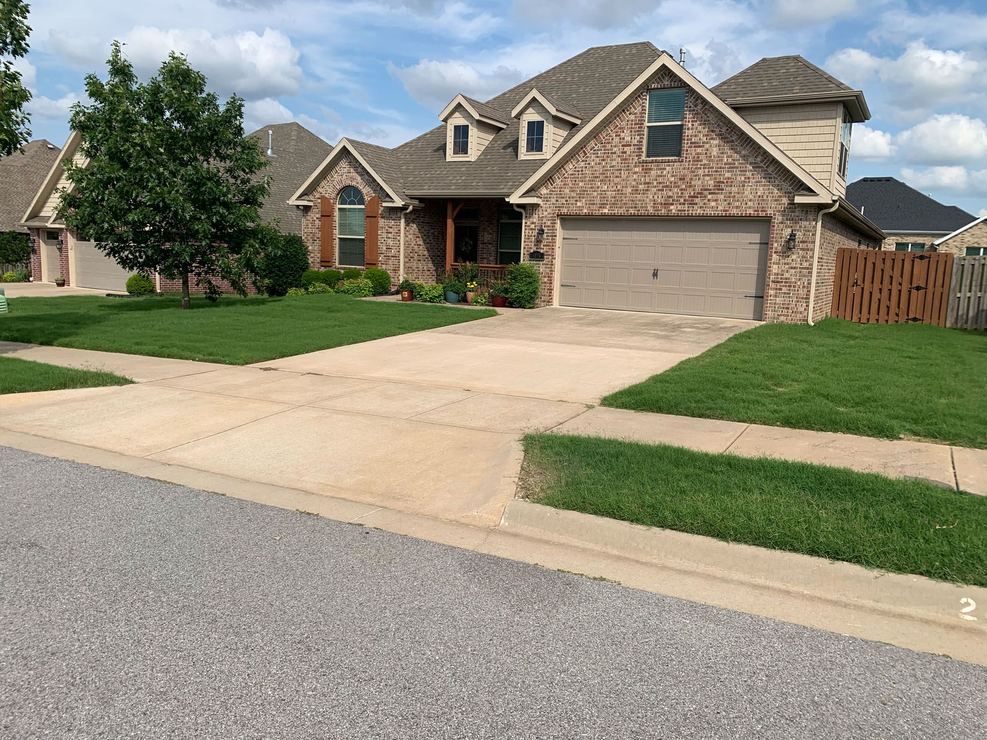 A brick house with a driveway in front of it