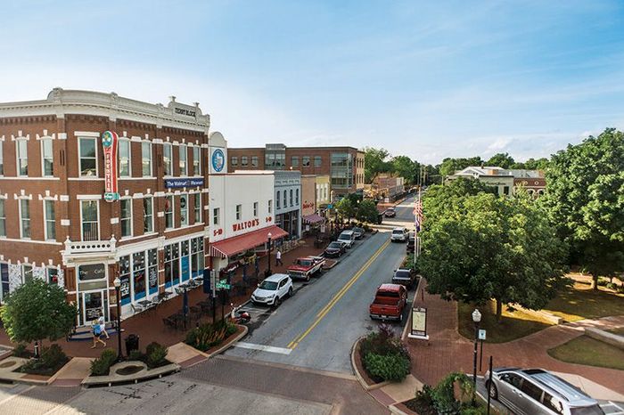 An aerial view of a small town with cars parked on the side of the road.