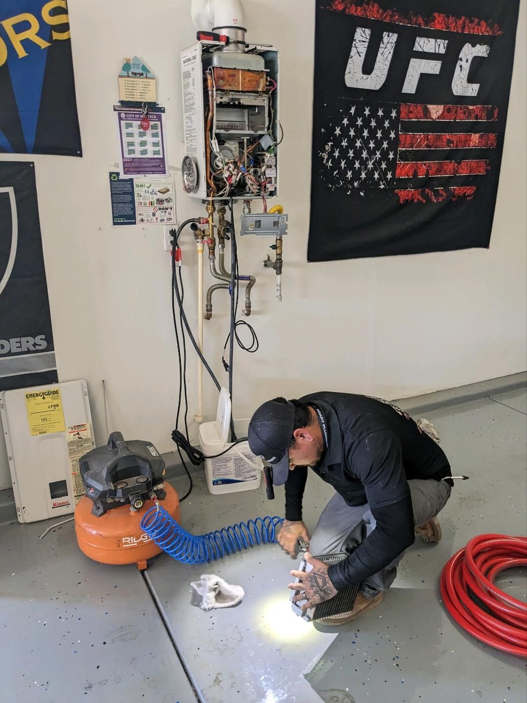 A man is working on a machine in front of a sign that says ufc