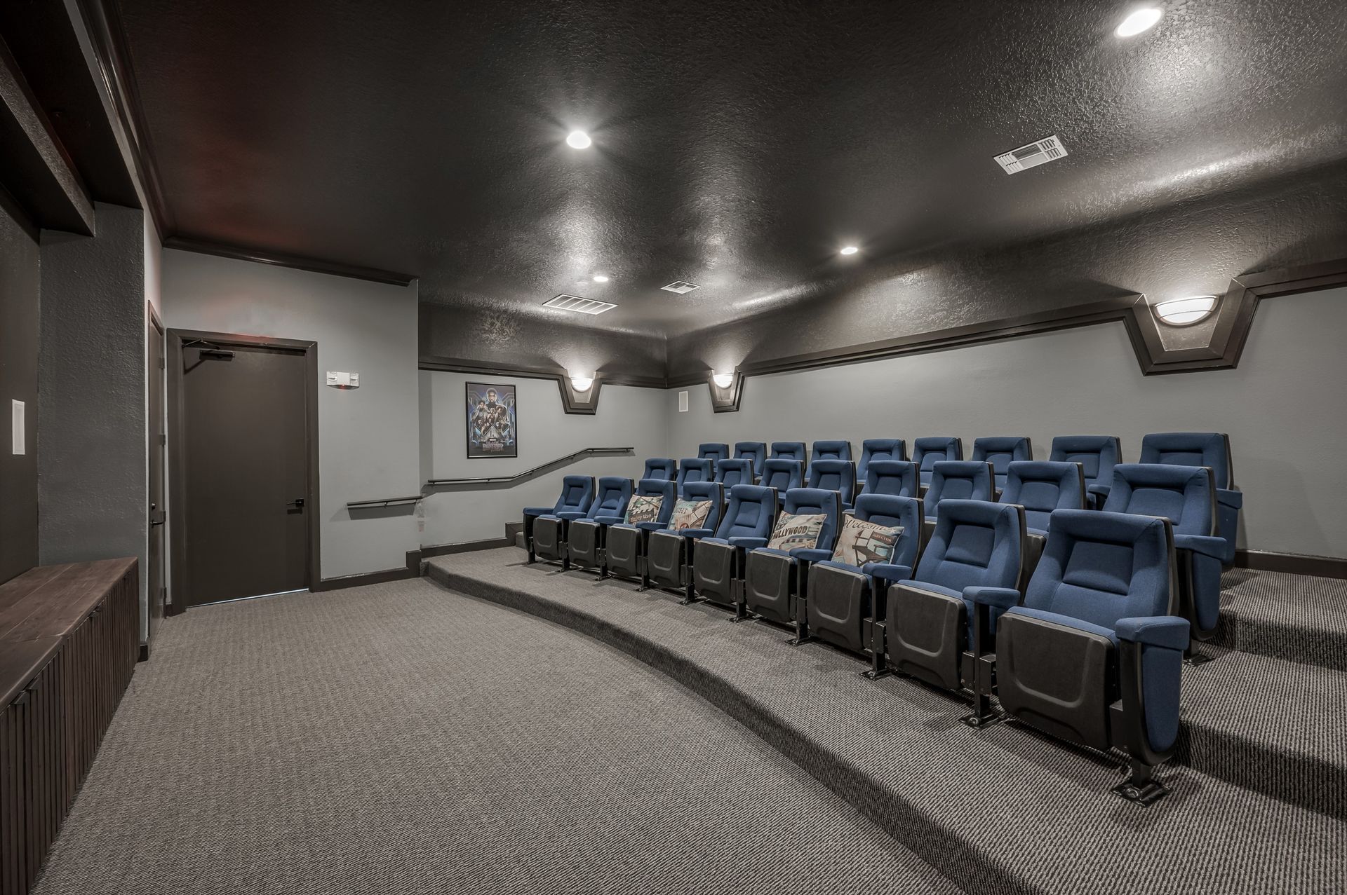 There are a lot of blue chairs in the theater.