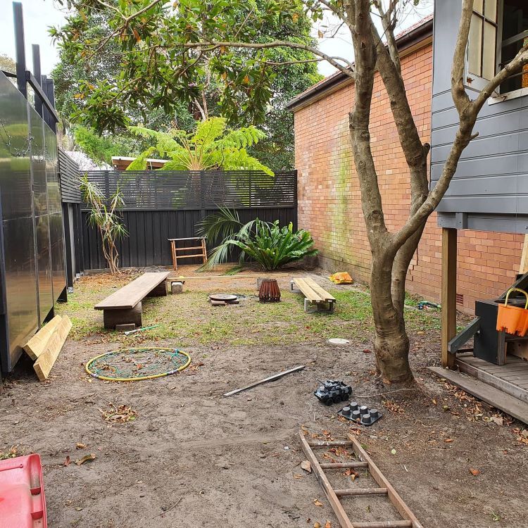 A Backyard With a Ladder, Benches, and a Fire Pit — Garden Vogue in Charlestown, NSW