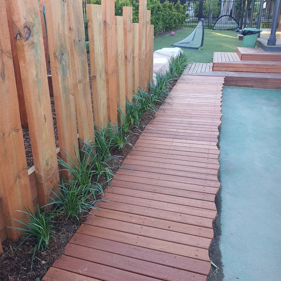 A Wooden Walkway Next to a Wooden Fence — Garden Vogue in Charlestown, NSW
