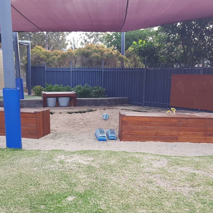 A Sandbox With a Purple Umbrella Over It — Garden Vogue in Charlestown, NSW