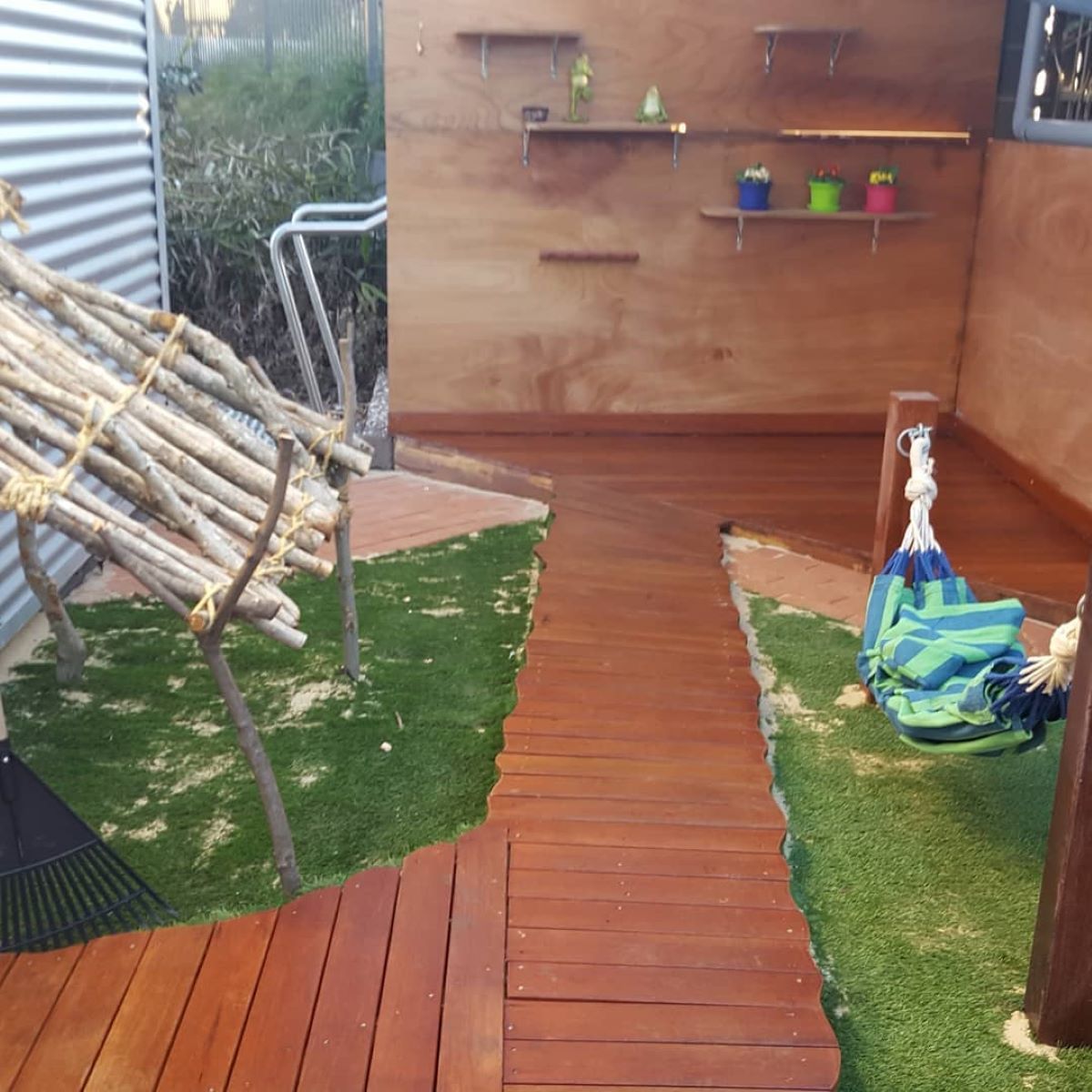 A Wooden Walkway Leading to a Room With a Hammock — Garden Vogue in Lake Macquarie, NSW