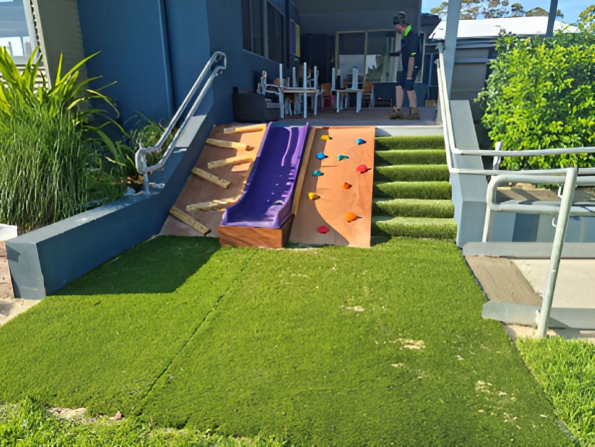 A Playground With a Slide and Stairs in Front of a House — Garden Vogue in Charlestown, NSW