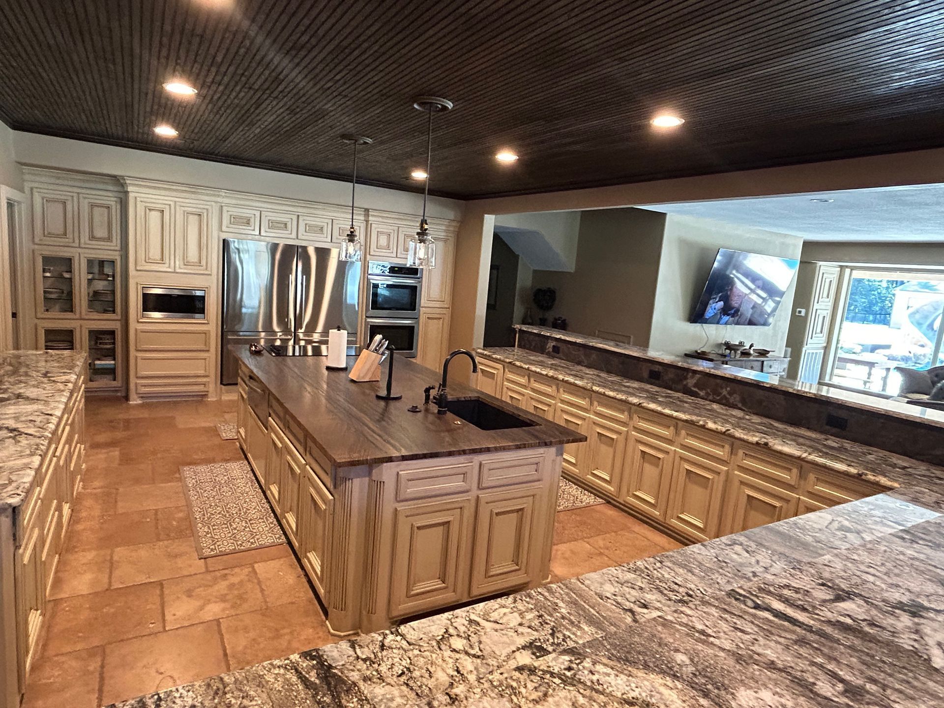 A large kitchen with granite counter tops and a large island in the middle.