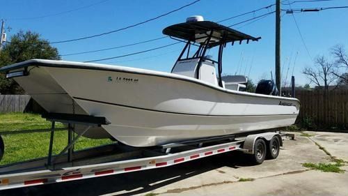 A white boat is sitting on top of a trailer.