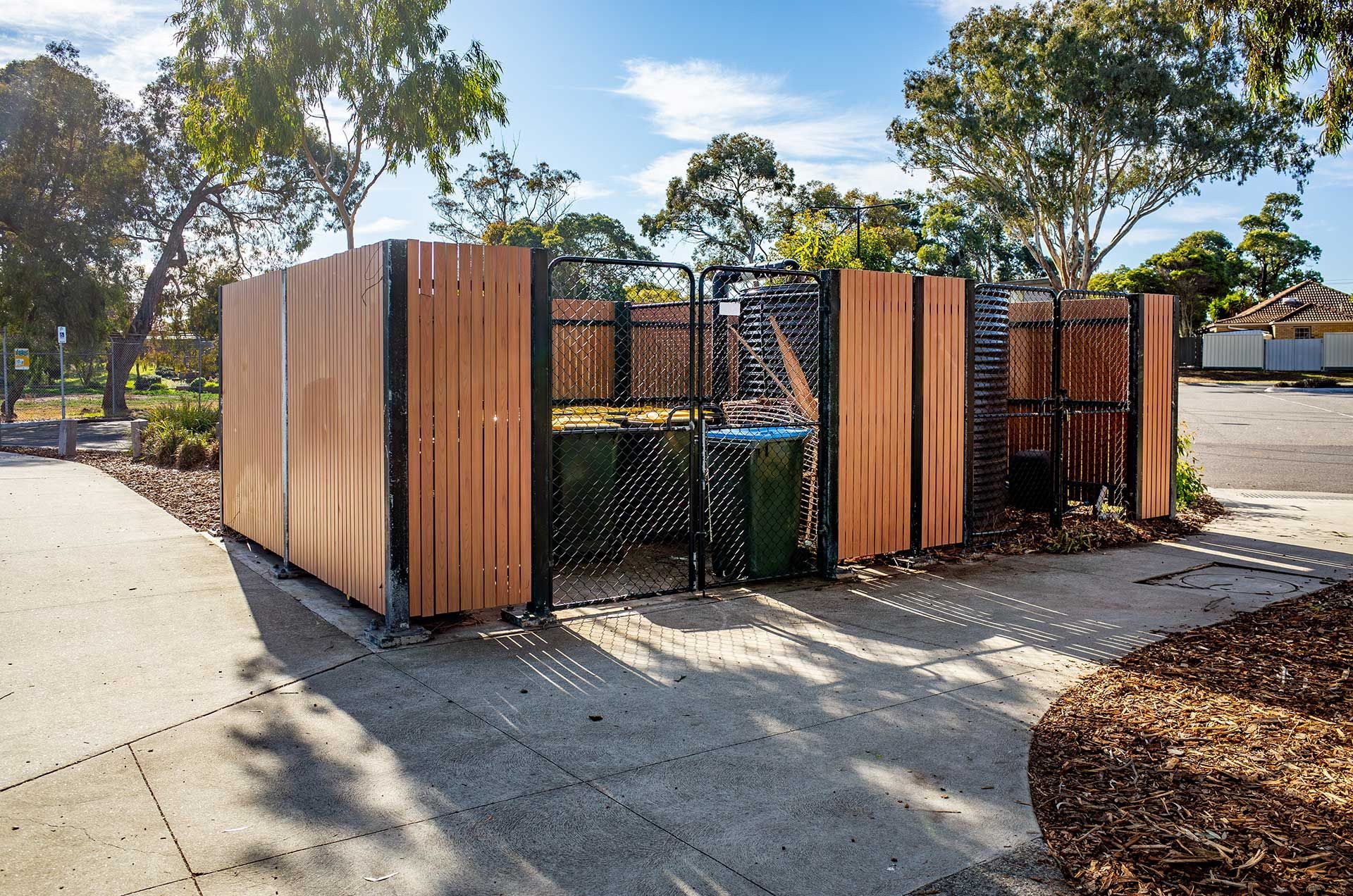 A secure public waste and recycling bin enclosure