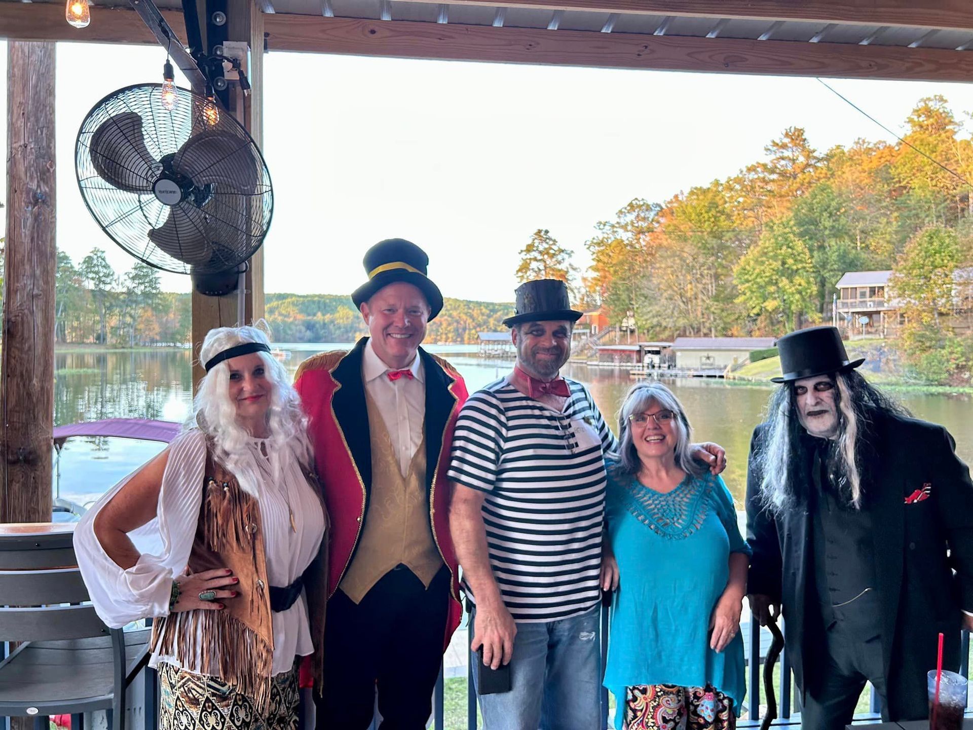 A group of people dressed in halloween costumes are posing for a picture.