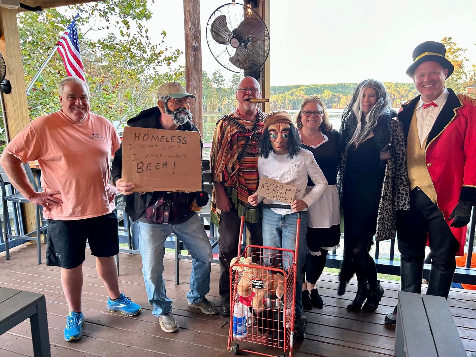 A group of people dressed in costumes are posing for a picture on a porch.