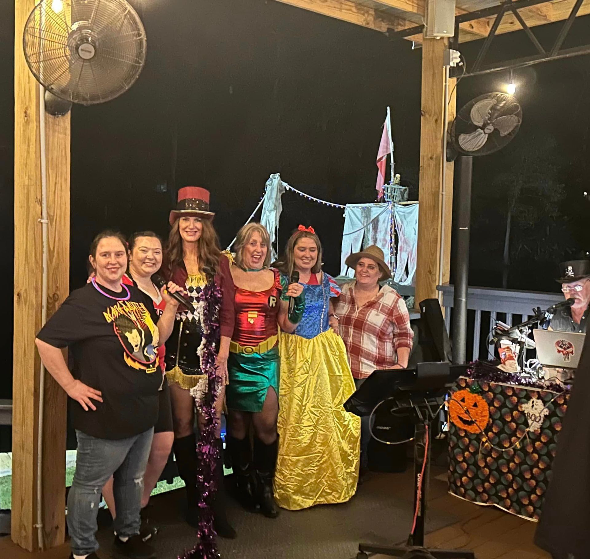 A group of women in costumes are posing for a picture