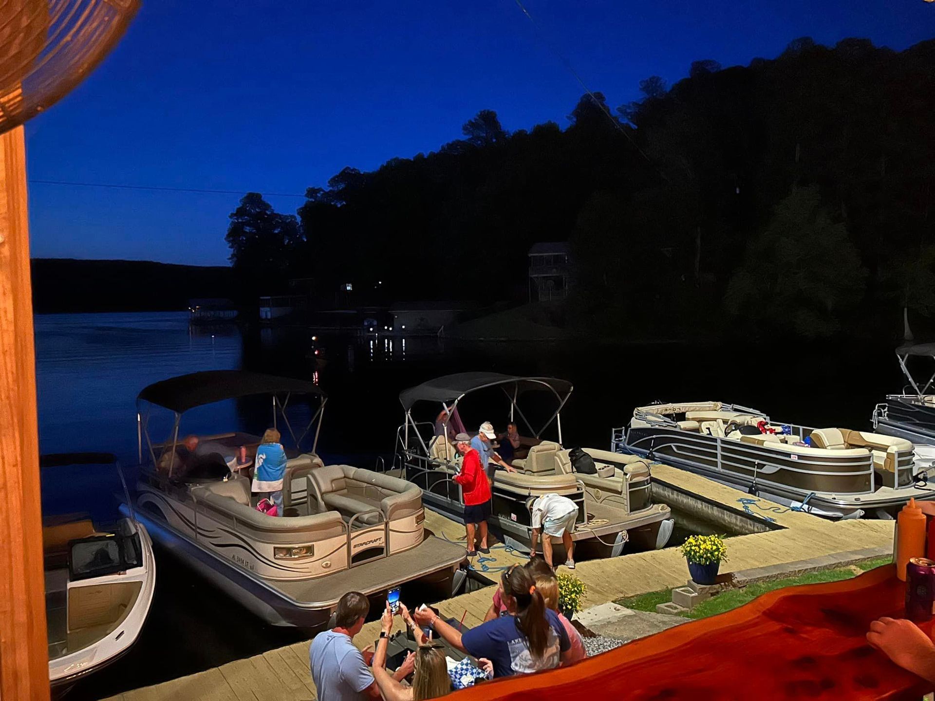 A group of people standing on a dock next to boats