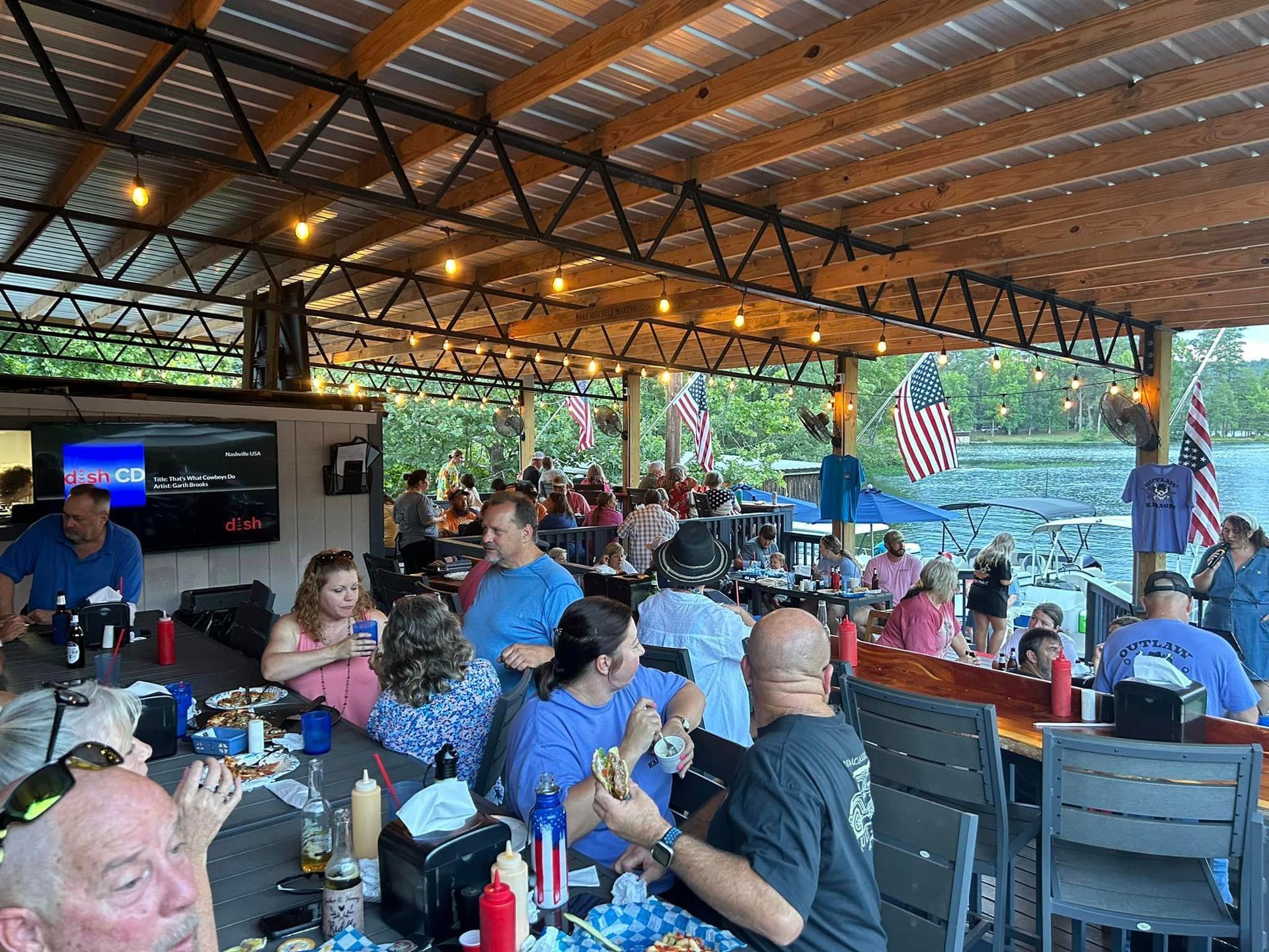 A large group of people are sitting at tables in a restaurant.