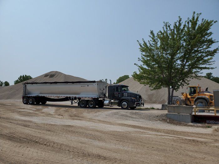 Black Truck and Excavator — Eden, WI — Baumhardt Sand & Gravel, Inc.
