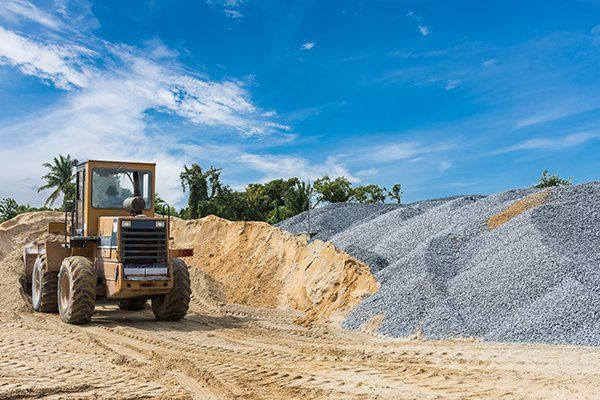 Pile of Sand and Stone with Tractor — Eden, WI — Baumhardt Sand & Gravel, Inc.
