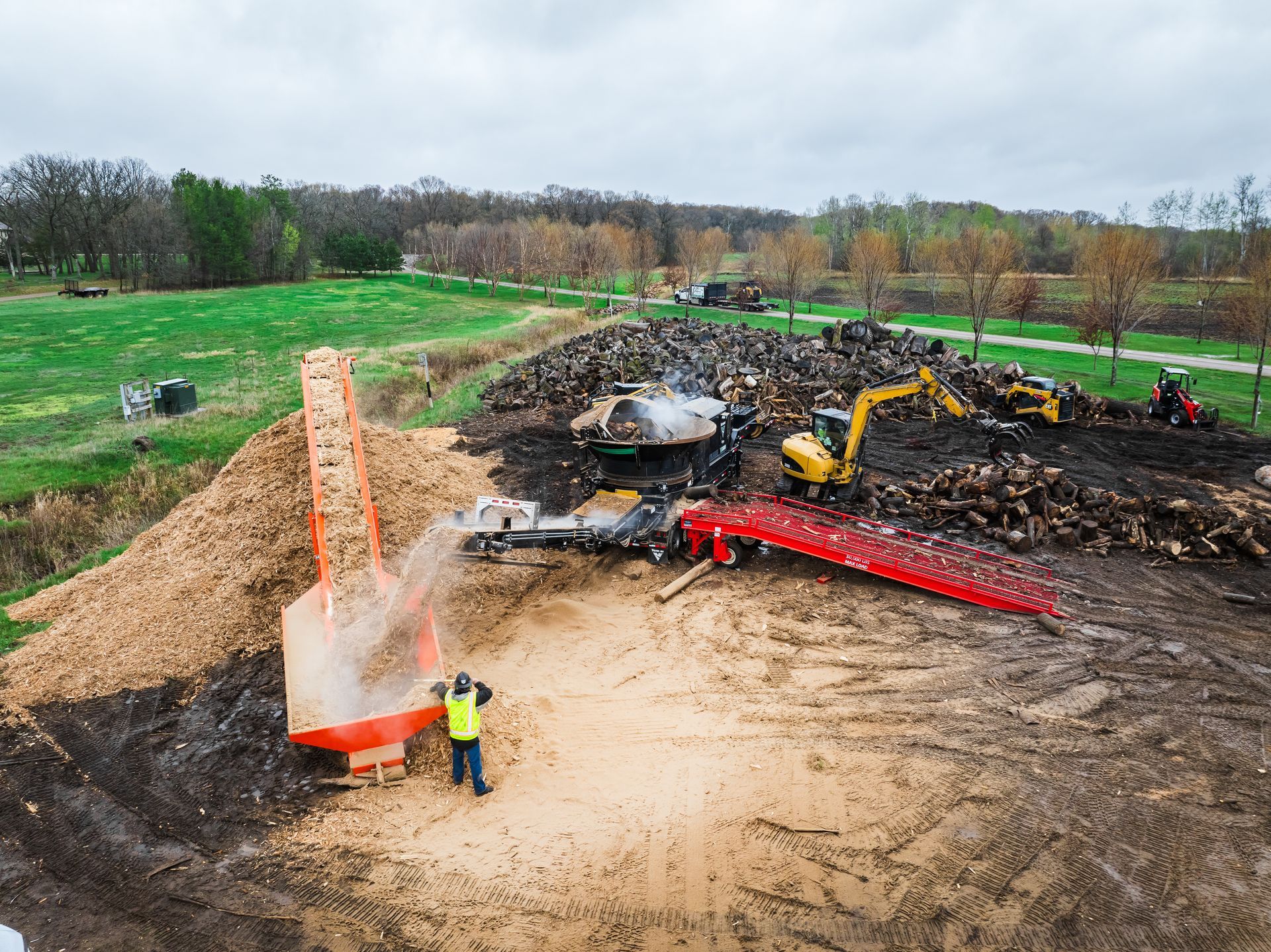 An aerial view of a construction site with a man standing in the middle of it.