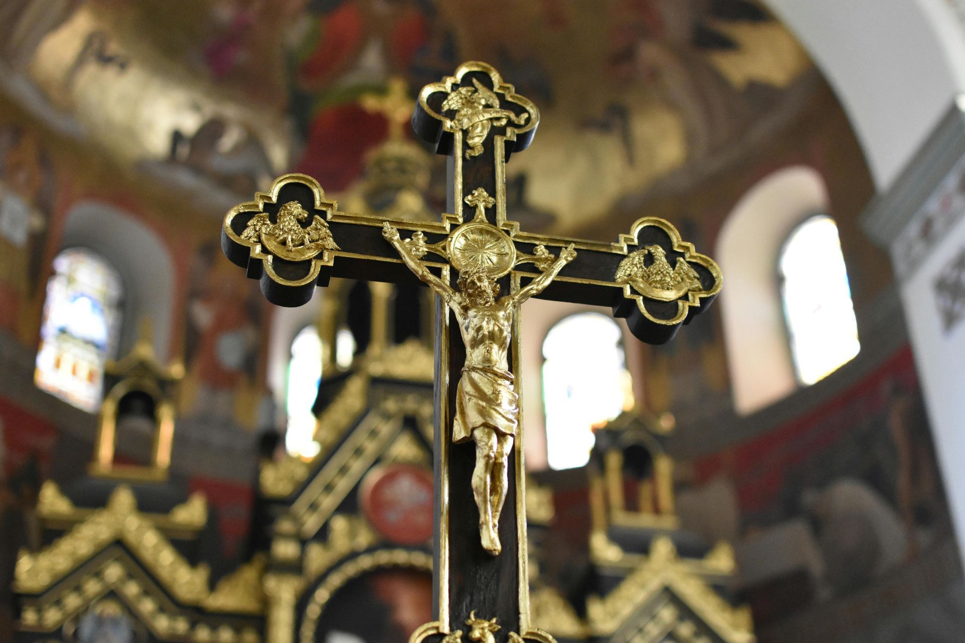 A cross with Jesus on it is in a church
