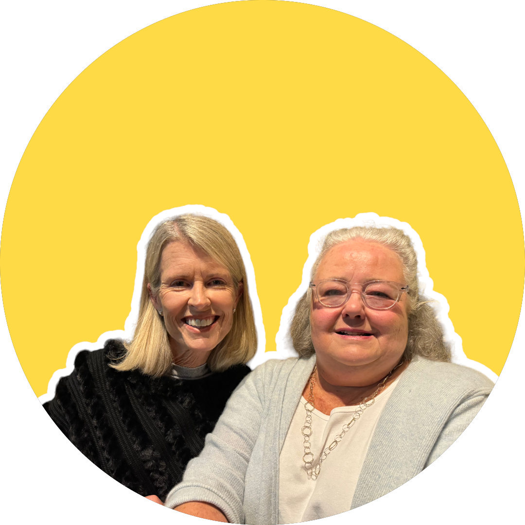 Two women are sitting next to each other in a yellow circle.