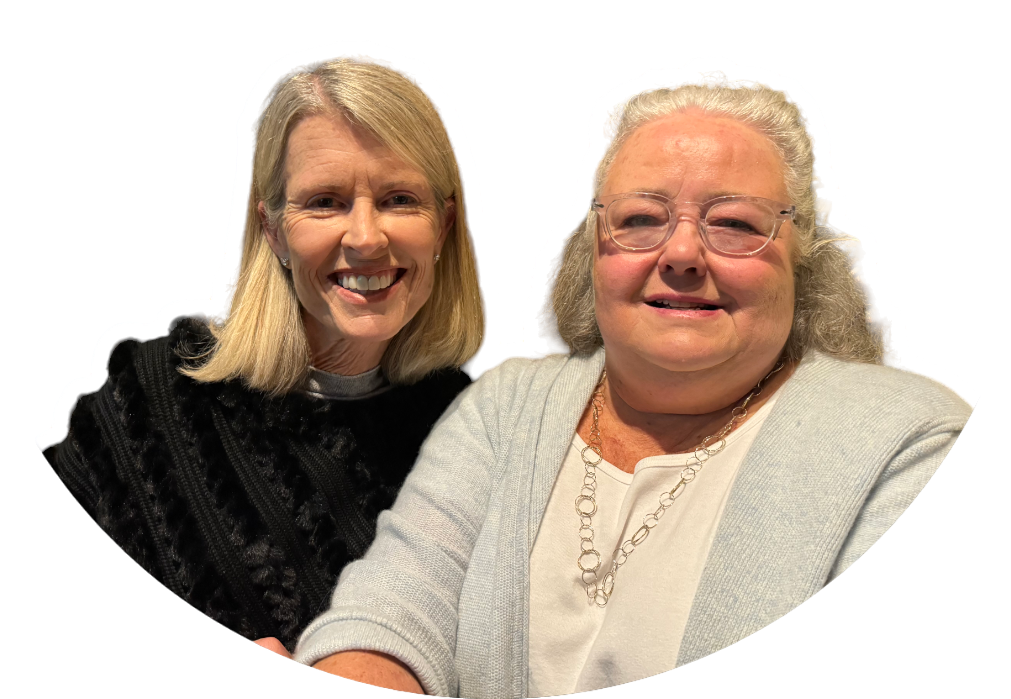 Two women are standing next to each other and smiling for the camera.