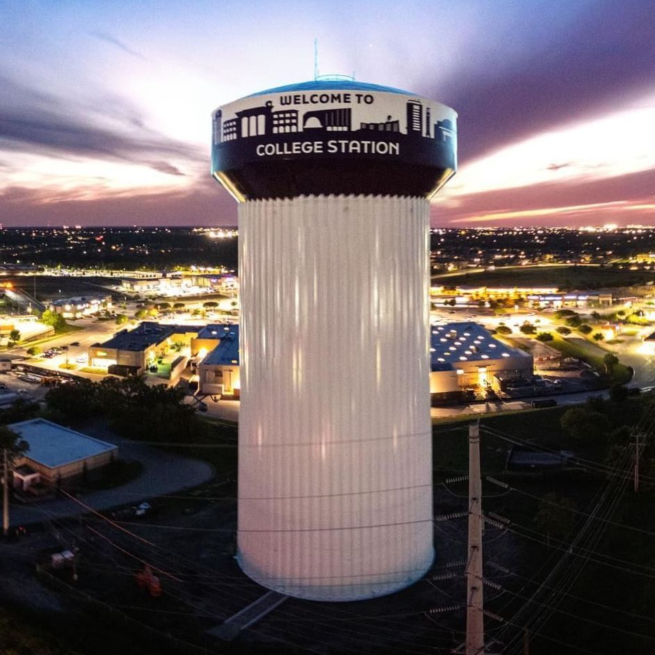 An aerial view of a water tower that says welcome to college station