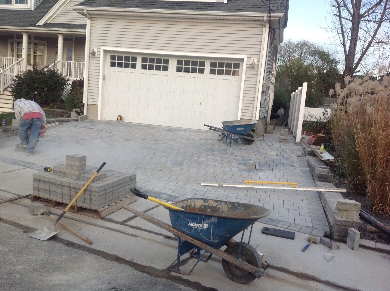 A wheelbarrow is sitting in front of a house.