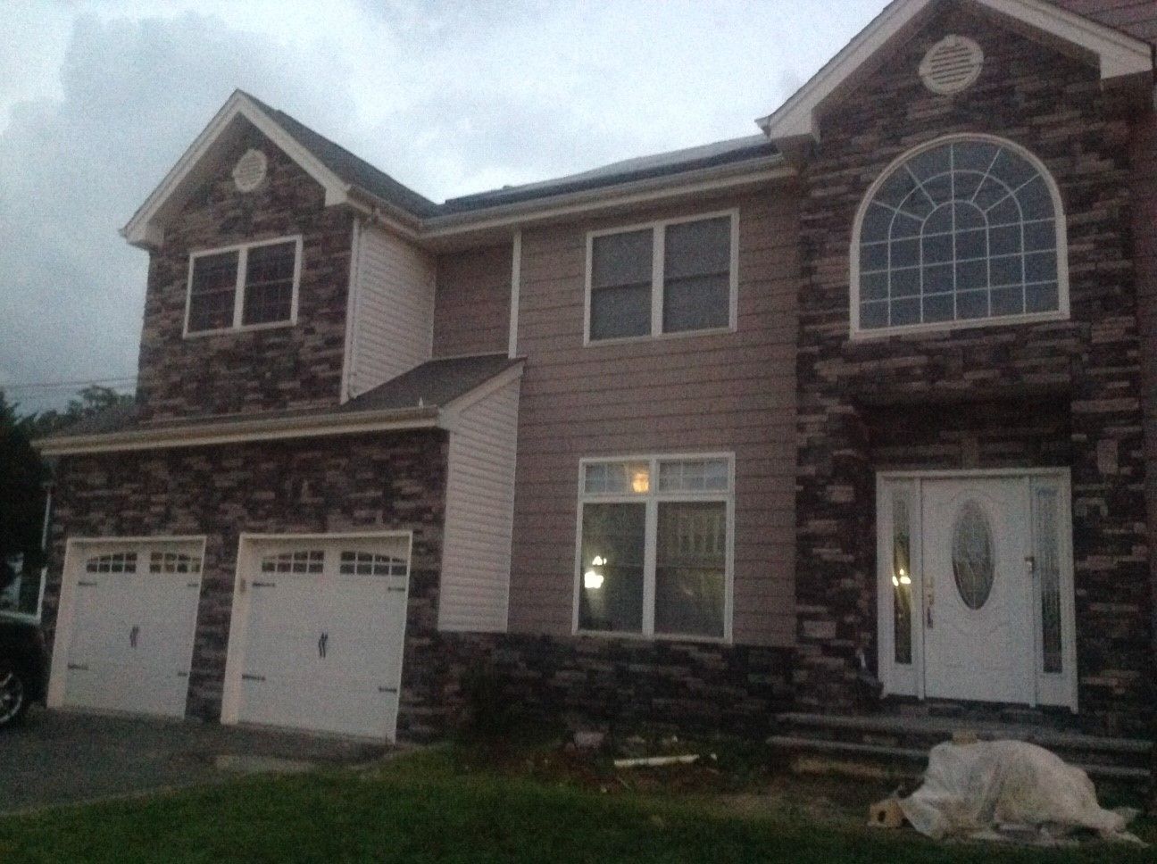 A large house with a dog laying in front of it