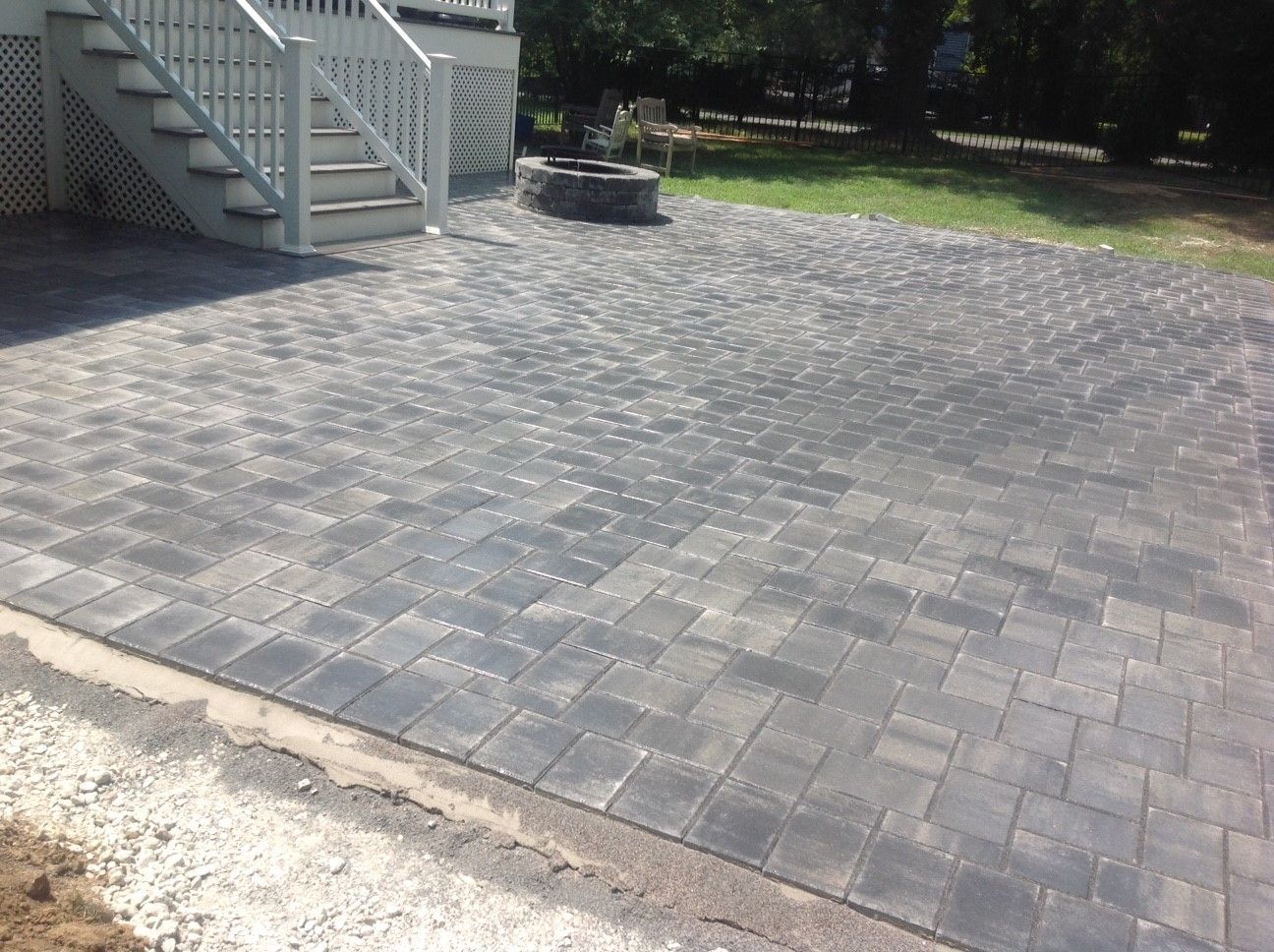 A patio with stairs and a fire pit in the backyard