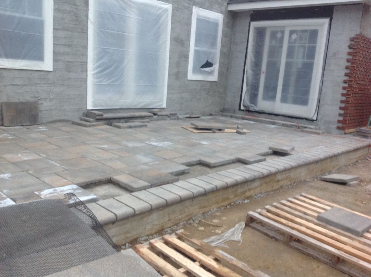 A patio is being built in front of a house