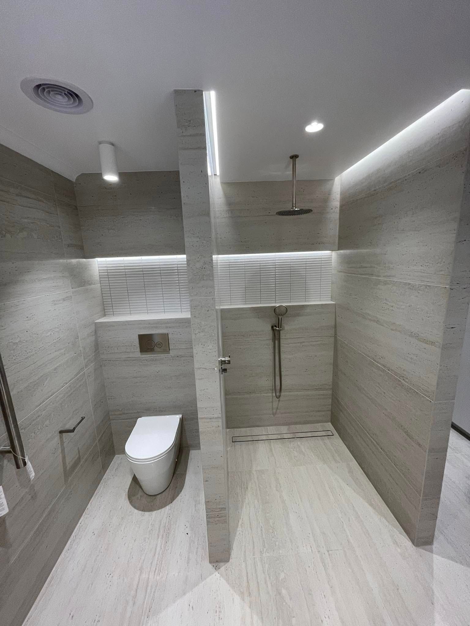 Modern, Accessible Bathroom with Gray Tiled Walls, Toilet — 2 Foote Plumbing & Gas in Darwin, NT