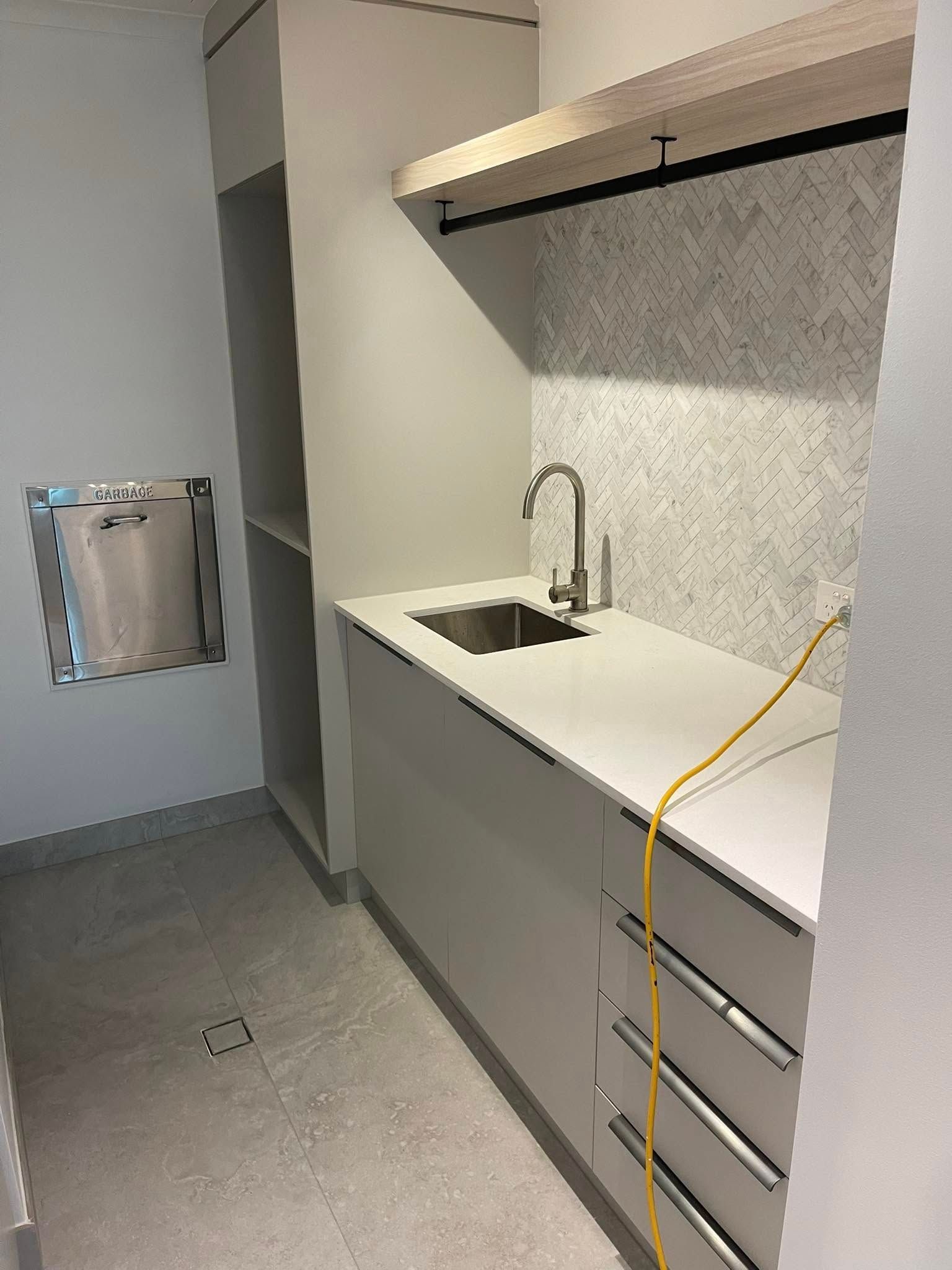 Laundry Room with A Sink, Cabinets, and Shelving — 2 Foote Plumbing & Gas in Darwin, NT