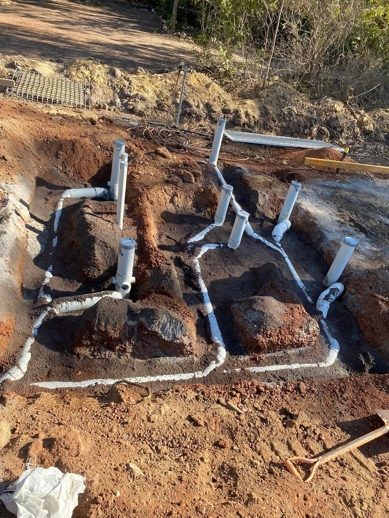 Construction Site: Exposed Plumbing Pipes in A Dirt Excavation — 2 Foote Plumbing & Gas in Darwin, NT
