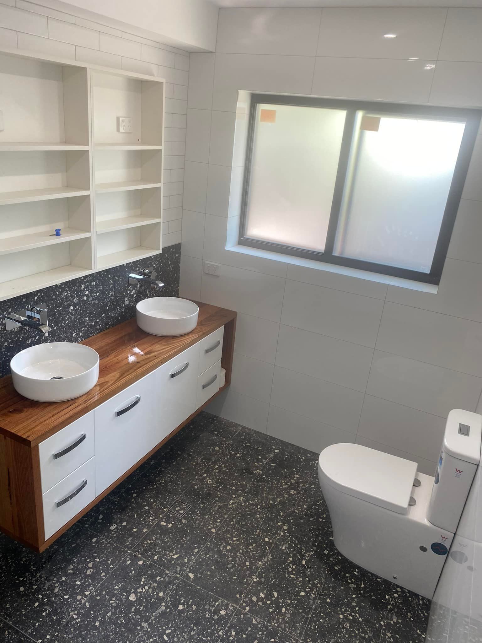 Modern Bathroom with A Floating Wooden Vanity, Two White Sinks, a Toilet — 2 Foote Plumbing & Gas in Darwin, NT