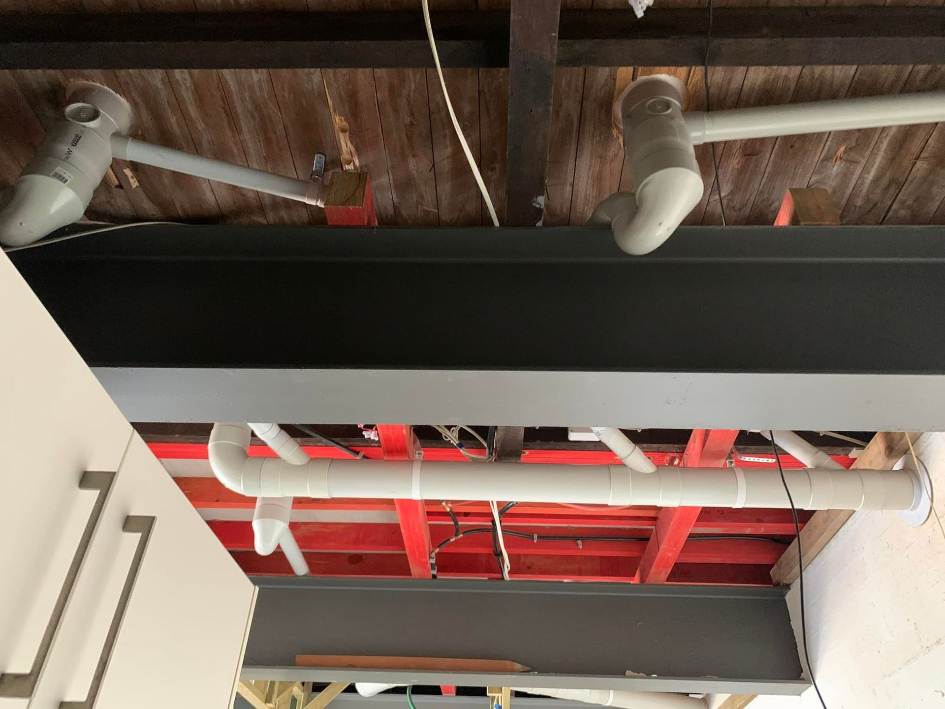 Gray Steel Beams Support a Ceiling with White and Gray Pvc Pipes — 2 Foote Plumbing & Gas in Darwin, NT
