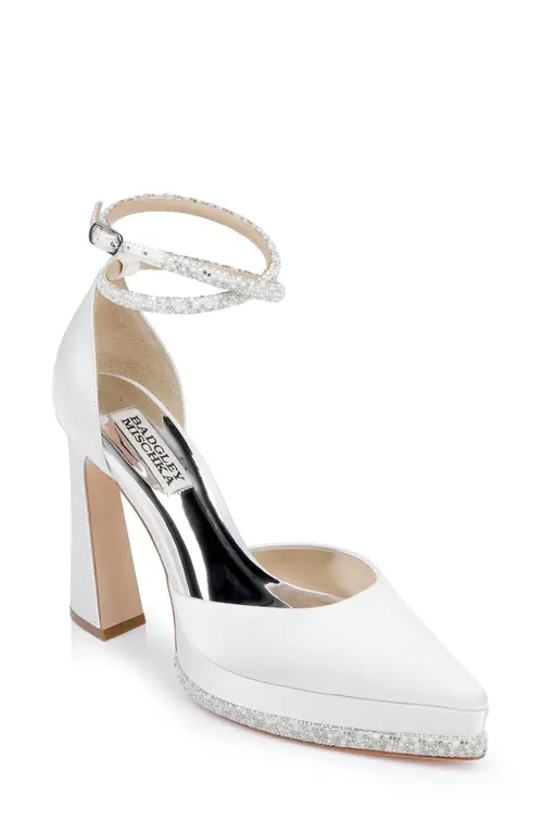 White satin bridal pump with a pointed toe and ankle strap. The platform and heel are adorned with embellishments.