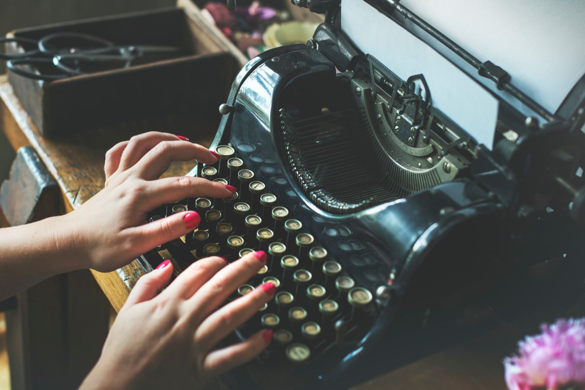 A Copywriter typing on an old typewriter 