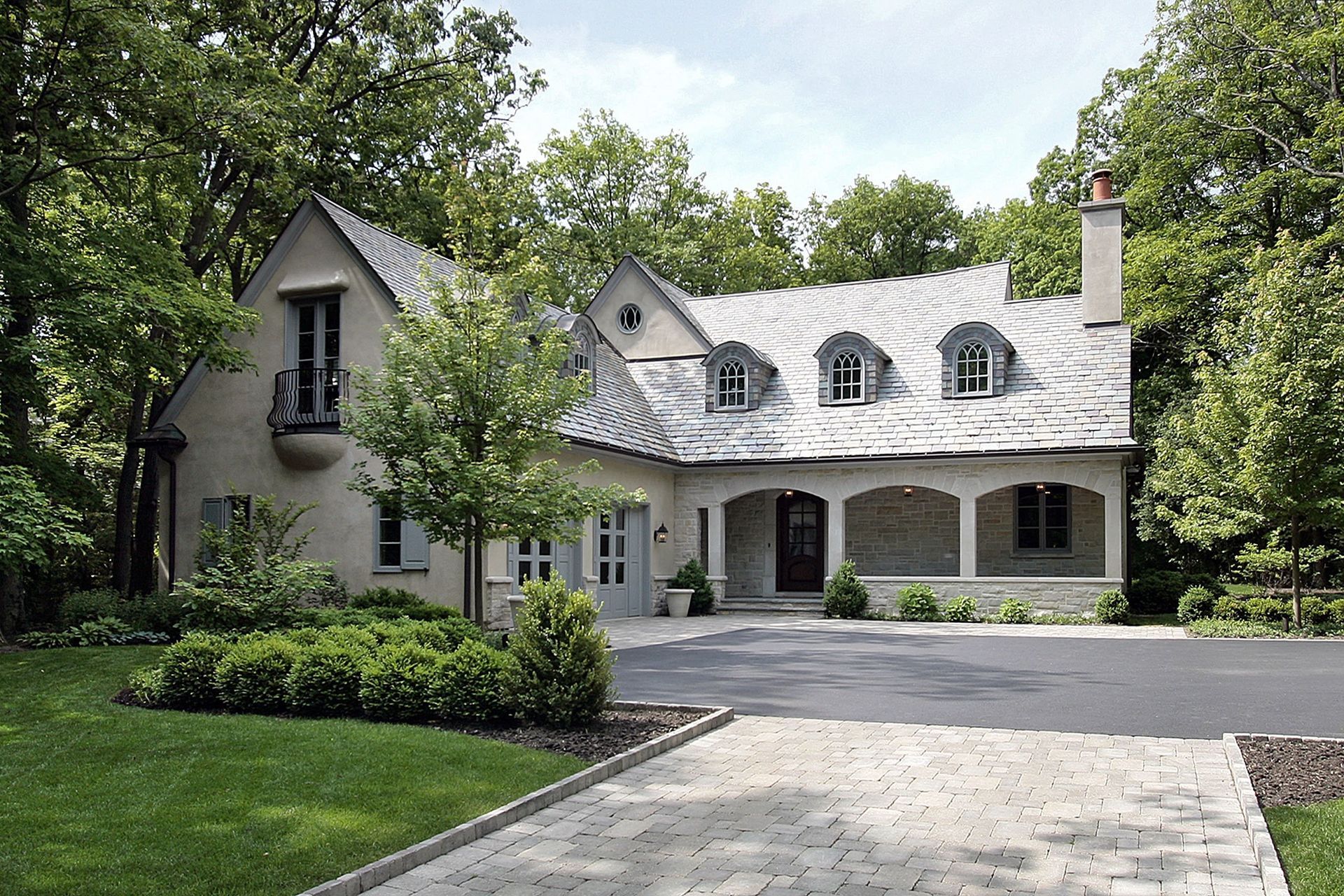 A large house with a large driveway in front of it