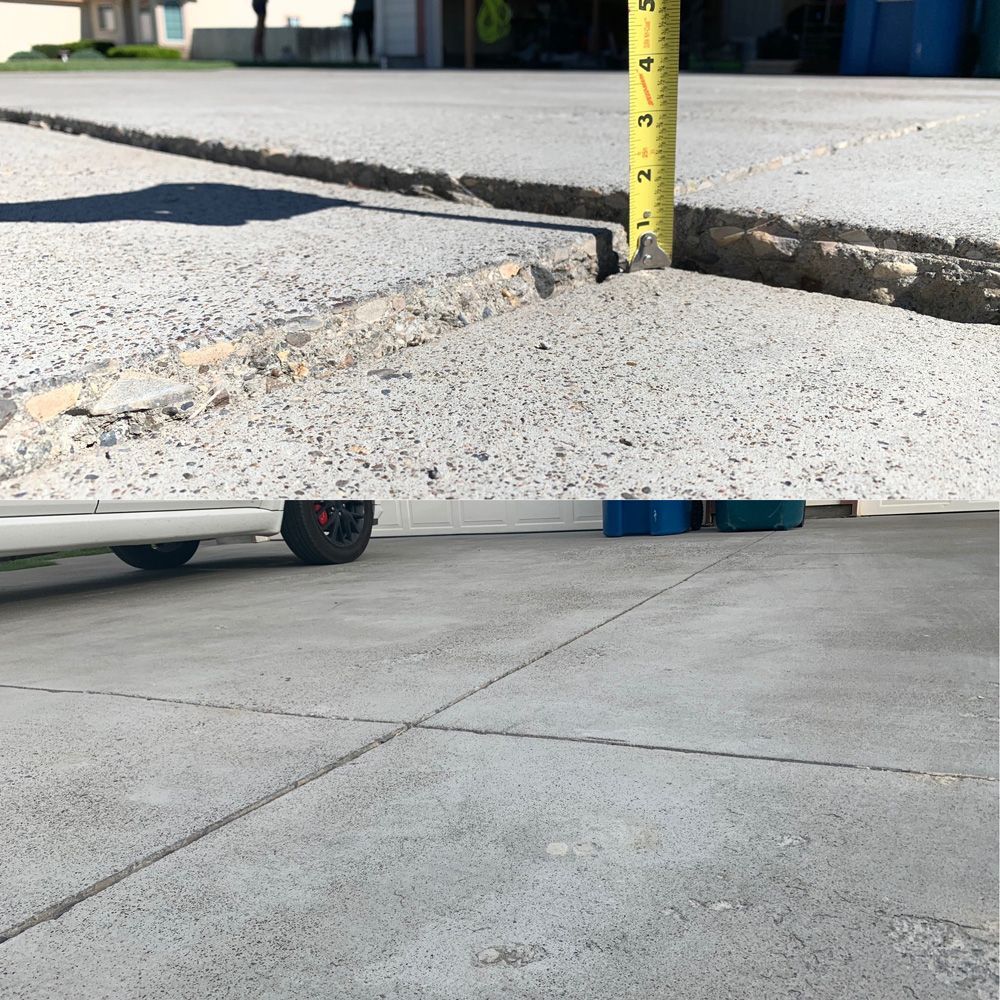 Cracked concrete with a measuring tape showing a large separation. Wheels and blue blocks are at the bottom.