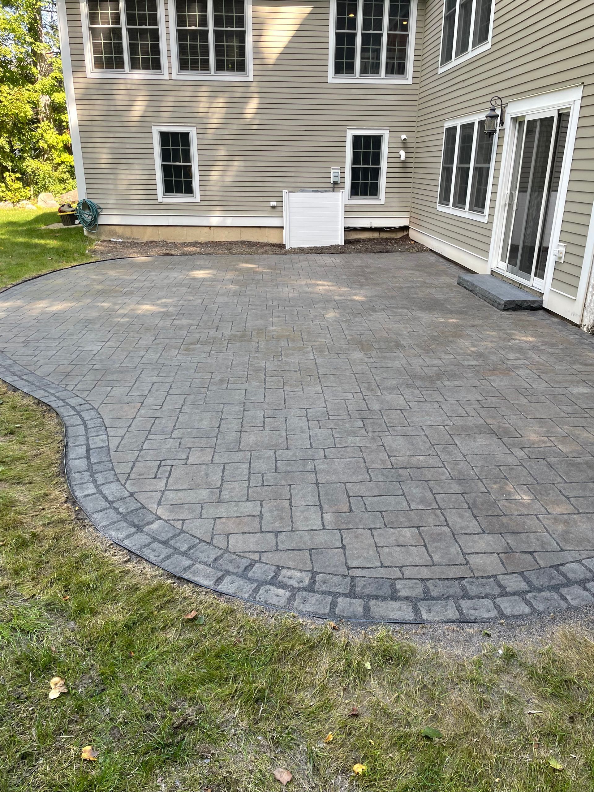 There is a patio in front of a house.