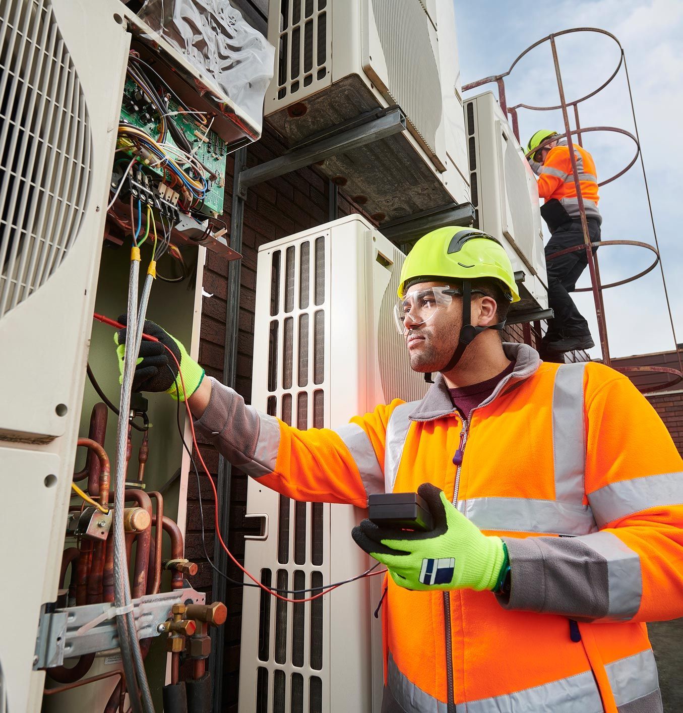HVAC contractors working on efficient commercial air conditioning repairs.