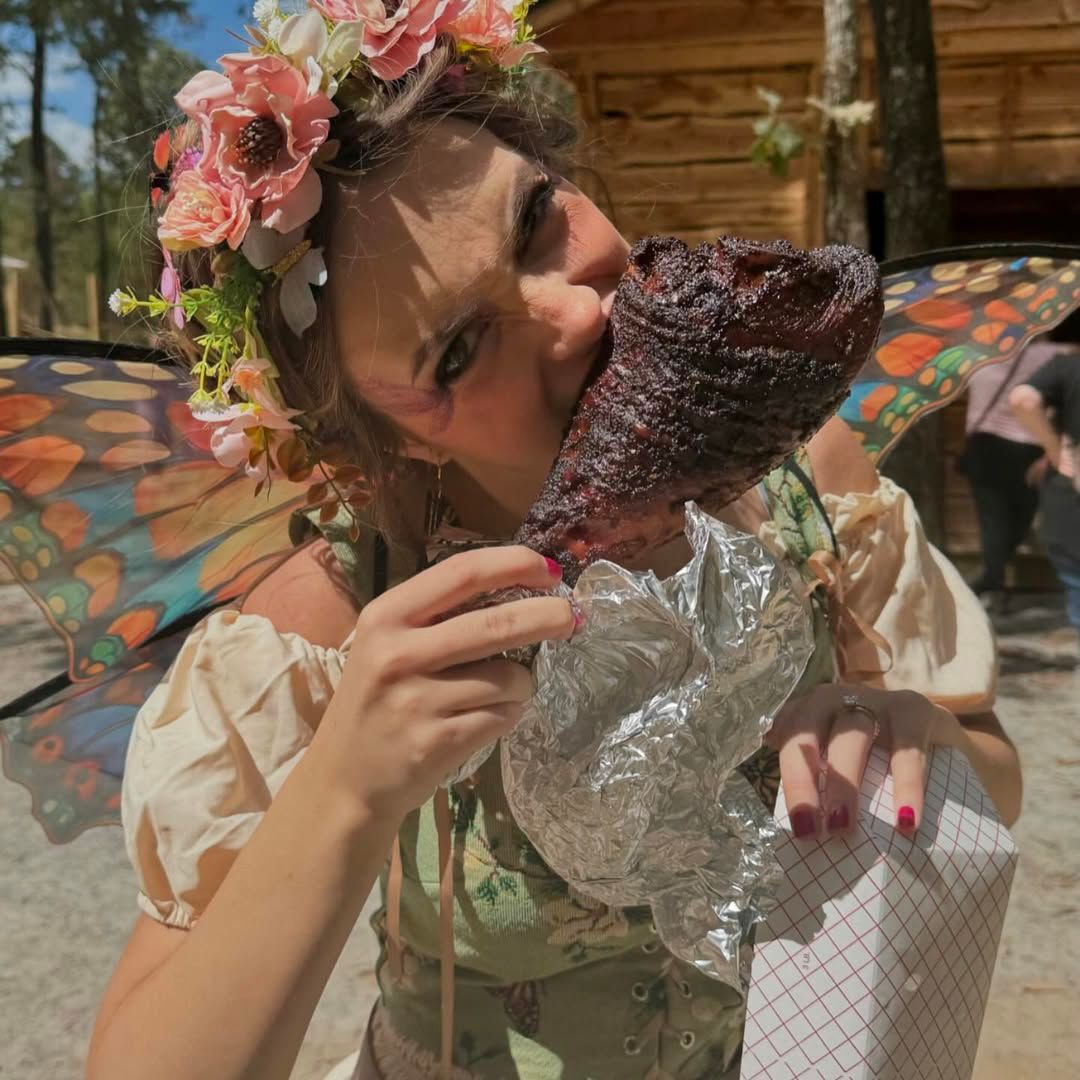 A group of people are sitting at tables with mugs on them.