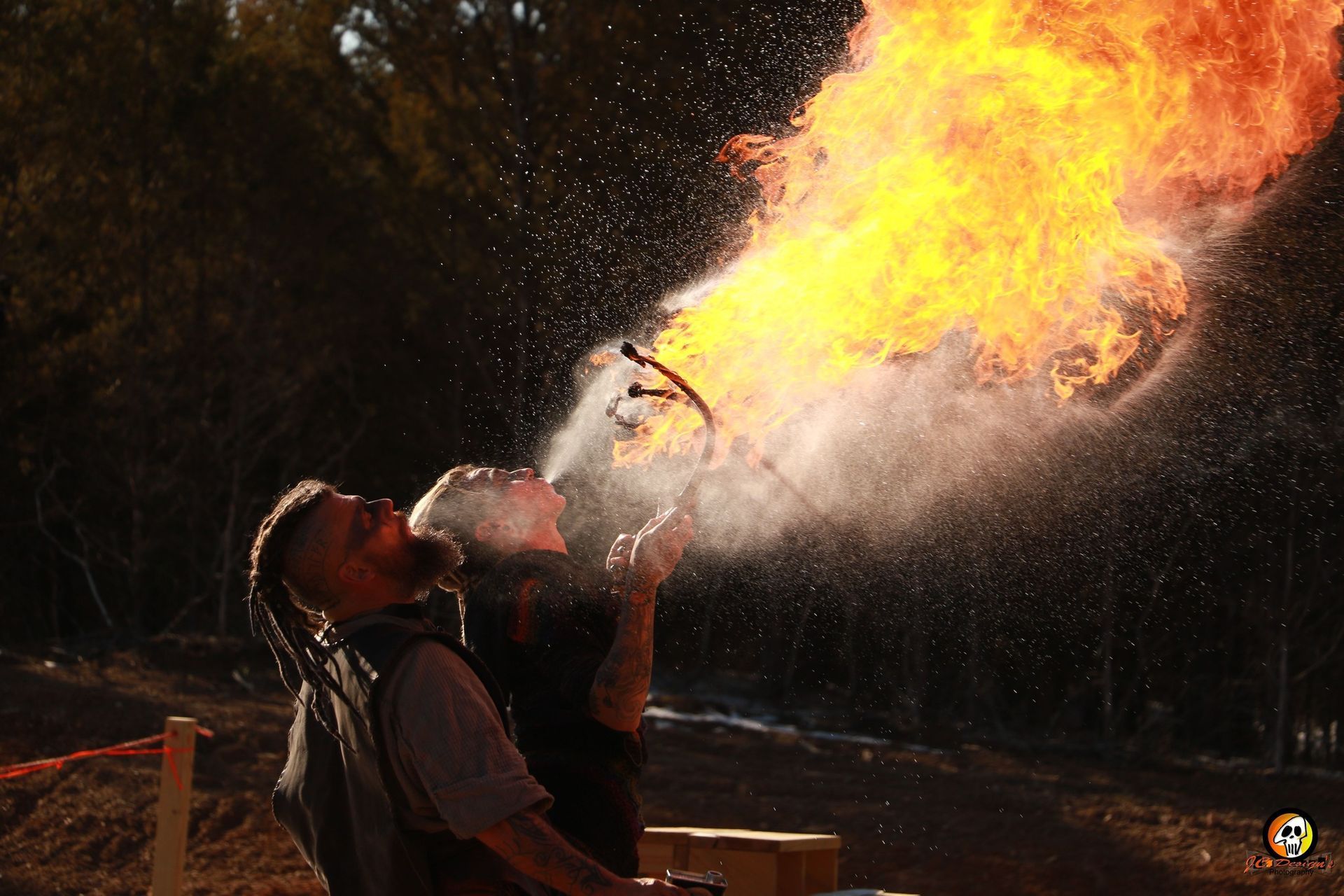 A man is blowing flames out of his mouth