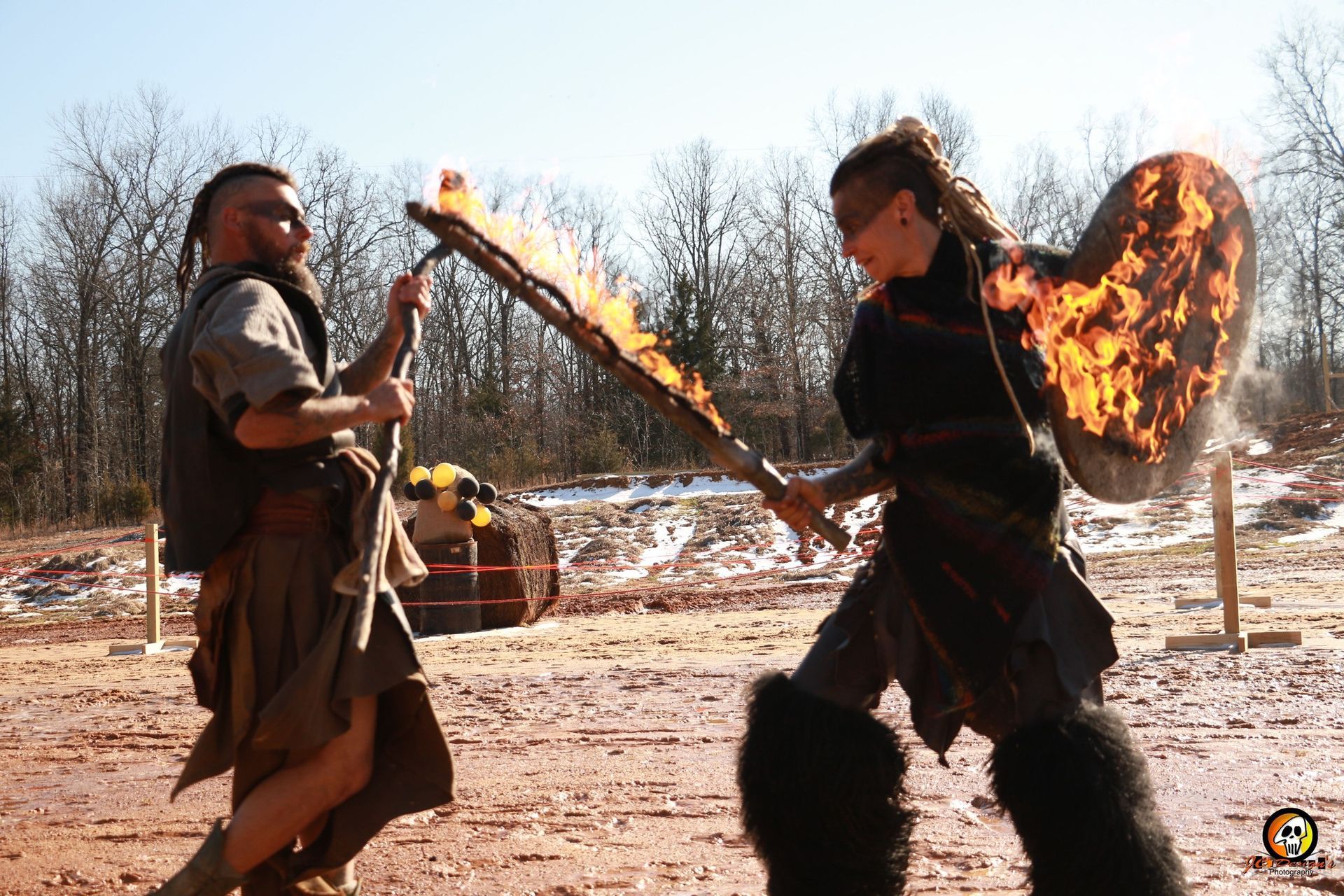 A man and a woman are fighting with a torch and shield