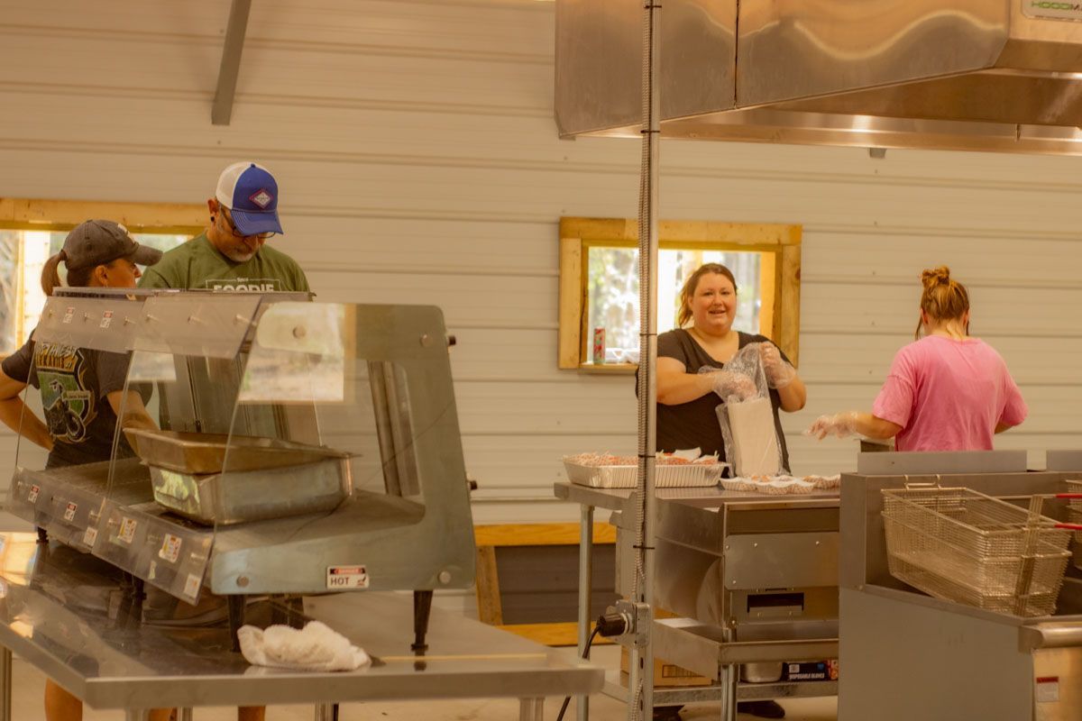 A group of people are working in a kitchen preparing food.