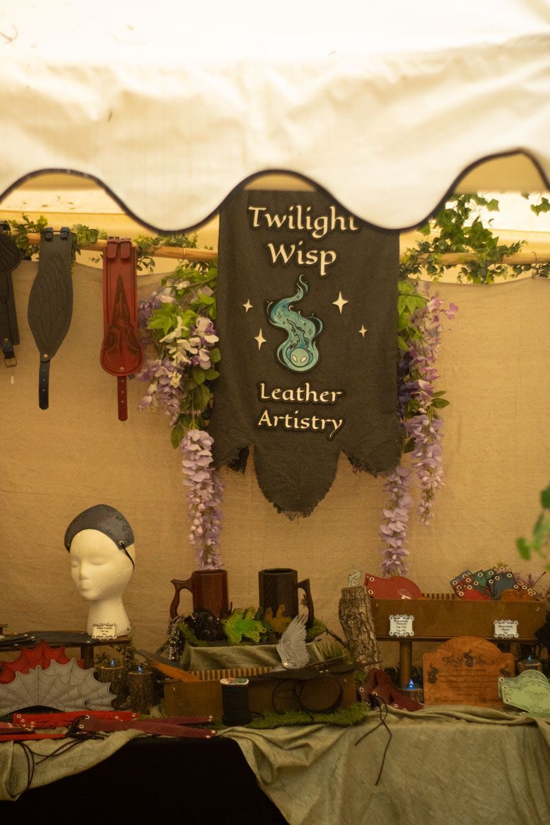 A table with a sign that says twilight wasp leather artistry