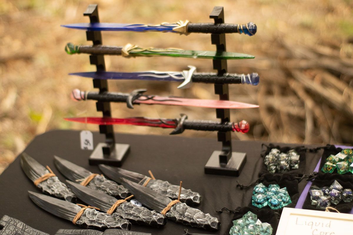 A table with a bunch of swords on it